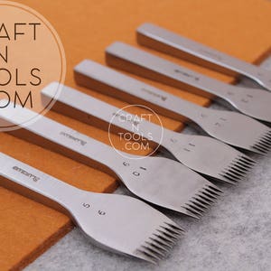 Puede incluir: Un conjunto de ocho herramientas de costura de cuero plateadas con agujas de diferentes tamaños. Las herramientas están dispuestas sobre una superficie marrón con las agujas orientadas hacia el lado derecho de la imagen. Las herramientas están etiquetadas con números del 5 al 12.