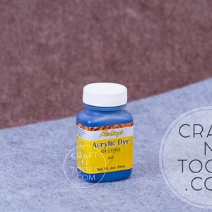 May include: A blue bottle of Fiebing's Acrylic Dye for Leather in the color blue. The bottle is labeled with the brand name, product name, and color. The bottle is 2 oz (59 ml).