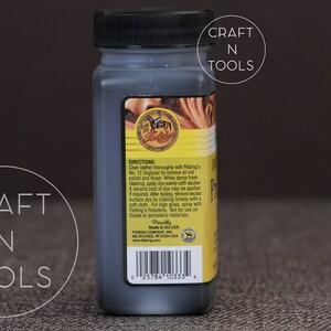 May include: A small black bottle of Fiebing's Leather Dye. The bottle has a yellow label with the Fiebing's logo and directions for use. The label also includes the text "Made in the U.S.A."