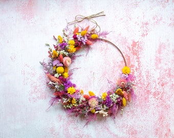 Dried Flower Hoop. A metallic hoop hand decorated with dried flowers, foliage and grasses in summer meadow colours. Alternative wreath.