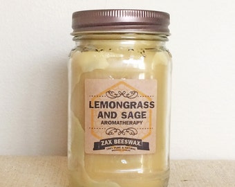 May include: A glass jar with a brown lid filled with a yellow beeswax candle. The label reads "Lemongrass and Sage Aromatherapy Zax Beeswax 100% Pure & Natural Beeswax Candles".