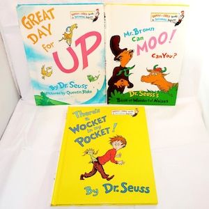 May include: Three Dr. Seuss children's books. The titles are "Great Day for Up", "Mr. Brown Can Moo! Can You?", and "There's a Wocket in my Pocket!". The books have colorful illustrations and text on the covers.
