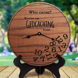 May include: A wooden clock with the text "Who cares? You're on Geocaching time..." and the numbers 1 through 12 scattered around the clock face.
