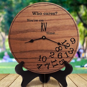 May include: A wooden clock with the text "Who cares? You're on RV time..." and the numbers 10, 2, 8, 11, 6, 1, 3, 9, 4, 7, 5, and 12 scattered around the clock face.