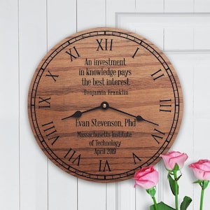 May include: A wooden clock with Roman numeral markings and a quote by Benjamin Franklin: "An investment in knowledge pays the best interest." The clock also includes the text "Evan Stevenson, Phd, Massachusetts Institute of Technology, April 2019."