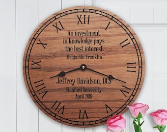 May include: A wooden clock with Roman numerals and a quote by Benjamin Franklin: "An investment in knowledge pays the best interest." The clock is personalized with the name Jeffrey Davidson, DCS, Stanford University, April 2019.