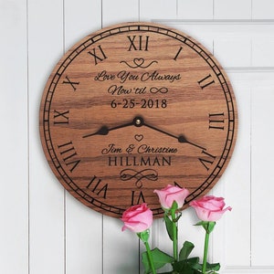 May include: A wooden clock with Roman numerals and a personalized message that reads "Love You Always Now 'til ∞ 6-25-2018 Tim & Christine HILLMAN".