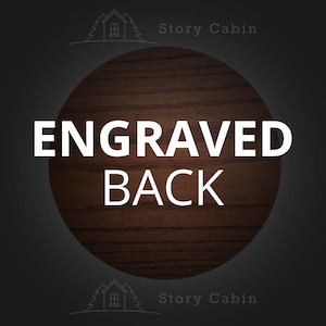 May include: A close-up of a round wooden sign with the text "ENGRAVED BACK" in white lettering. The sign is made of dark wood with a natural grain pattern. The text "Story Cabin" appears in white lettering at the top and bottom of the image.
