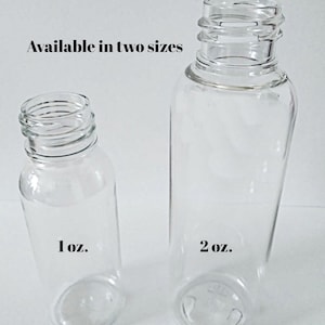 May include: Two clear glass bottles, one labeled "1 oz." and the other "2 oz." The bottles are cylindrical with a threaded neck. The text "Available in two sizes" is above the bottles.