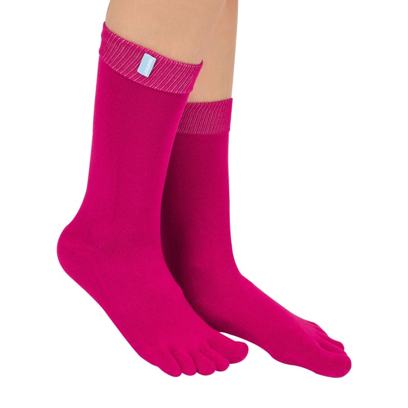 May include: A pair of pink toe socks with a ribbed texture. The socks are made of a soft, comfortable material and have a light blue label on the top.