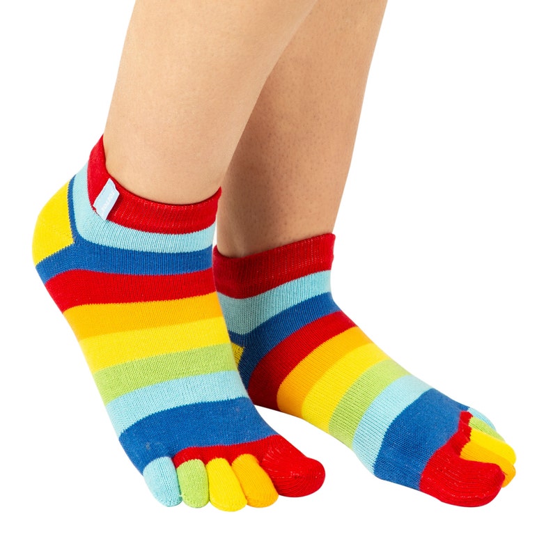 May include: A pair of colorful toe socks with horizontal stripes in red, orange, yellow, green, blue, and purple. The socks have a separate compartment for each toe and a red cuff.