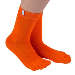 May include: A pair of orange toe socks with a light blue label on one sock.