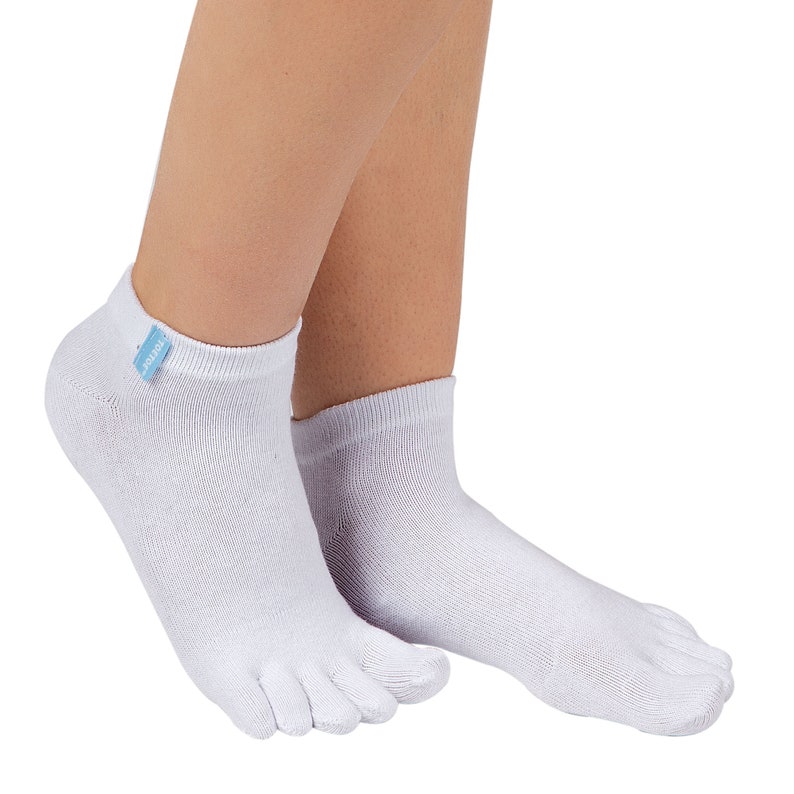 May include: White toe socks with a small blue tag on the cuff. The socks have individual compartments for each toe. The socks are made of a soft, breathable material.