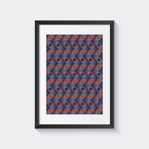 Puede incluir: Una impresión enmarcada de un patrón geométrico en tonos de azul, rojo y amarillo. El patrón está formado por círculos y cuadrados repetidos.