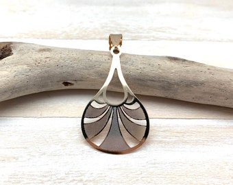 May include: Gold pendant with a geometric design. The pendant is shaped like a teardrop and has a cutout pattern.