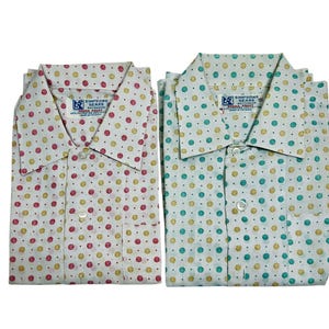 May include: Two white button-down shirts with a polka dot pattern. One shirt has red and yellow dots, and the other has green and yellow dots. Both shirts have a label that reads "Simpson Sears Outfitters, Penna.  Penn."