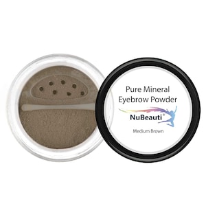 May include: A round container of NuBeauti Pure Mineral Eyebrow Powder in Medium Brown. The powder is visible in the container. The container has a sifter lid and a small applicator brush.