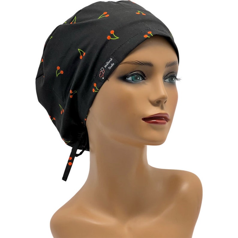 May include: Black scrub cap with a cherry print and a small red label that says "MedScrub Studio".