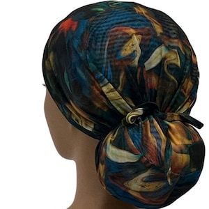 May include: A colorful surgical scrub hat with a blue, green, orange, and yellow abstract pattern. The hat is tied at the back of the head.