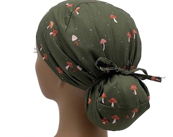 May include: A green scrub hat with a white polka dot pattern and a mushroom print. The hat has a tie at the back.