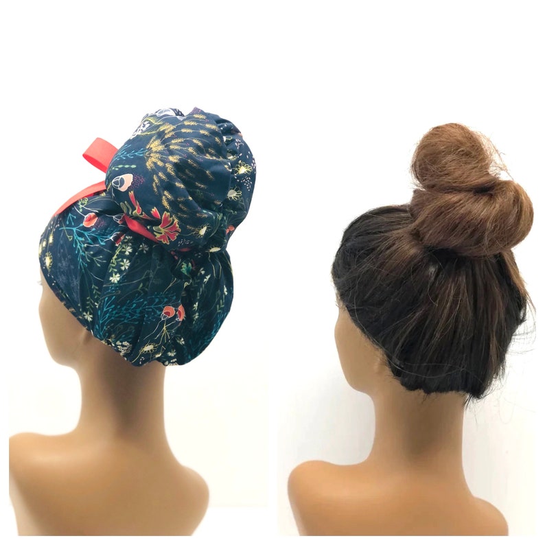 May include: Two mannequins, one wearing a blue and floral print fabric bun cover with a red ribbon, and the other with a brown bun hairstyle.