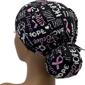 May include: Black scrub hat with a pink ribbon and the words "Hope", "Faith", "Love", and "Care" printed in white.