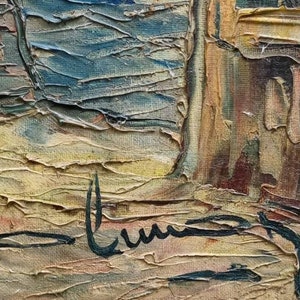 May include: A close-up of a painting with a textured, abstract style. The painting features a variety of colours, including brown, yellow, blue, and green. The artist's signature is visible in the bottom right corner of the painting.