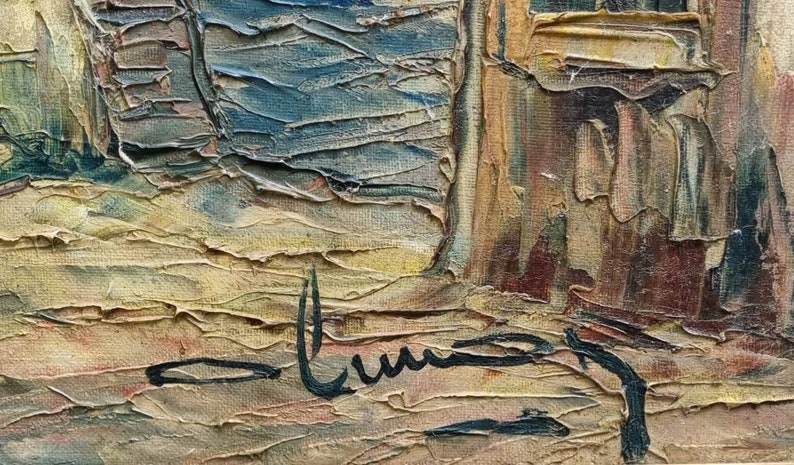 May include: A close-up of a painting with a textured, abstract style. The painting features a variety of colours, including brown, yellow, blue, and green. The artist's signature is visible in the bottom right corner of the painting.