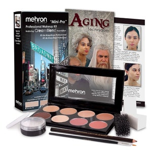 May include: A professional makeup kit for aging techniques, featuring a palette of eight cream-based foundation shades, a sponge, a brush, a pencil, and a booklet titled "Aging Techniques". The kit is labeled "mehron "Mini-Pro" Professional Makeup Kit featuring: Cream Blend Foundation".