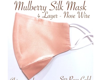 May include: A light pink mulberry silk face mask with a nose wire and chin guard. The mask is labeled "4 Layer - Nose Wire" and "S12 Rose Gold".