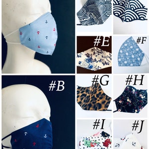 May include: Collection of face masks in various patterns and colors. Includes light blue with red anchors, navy with red anchors, black and white wave design, floral, and leopard print.