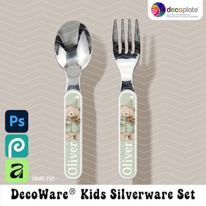 May include: A stainless steel spoon and fork set for kids. Each utensil has a white handle with a cartoon bear design and the name "Oliver" printed on it. The set is part of the DecoWare Kids Silverware Set.