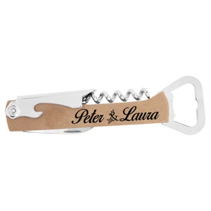 May include: A multi-tool with a corkscrew, bottle opener, and knife. The handle is tan with the names "Peter & Laura" engraved in black script. The tool has a silver metal finish.