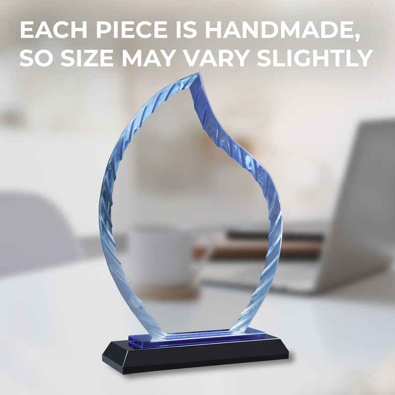 May include: A blue glass award with a flame-shaped design. The award has a black base and a blue accent.