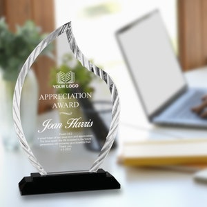 May include: A clear glass award in the shape of a flame with a black base. The award has the text "YOUR LOGO", "APPRECIATION AWARD", "Joan Harris", "Psalm 24:2", "A small token of our deep love and appreciation. The time spent, the life invested in the future generations will someday give bountiful fruit. Thank you. 4-5-2022" engraved on it.