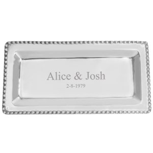 May include: A rectangular silver serving tray with a beaded border. The tray is engraved with the names "Alice & Josh" and the date "2-8-1979". The tray has a polished, reflective surface.