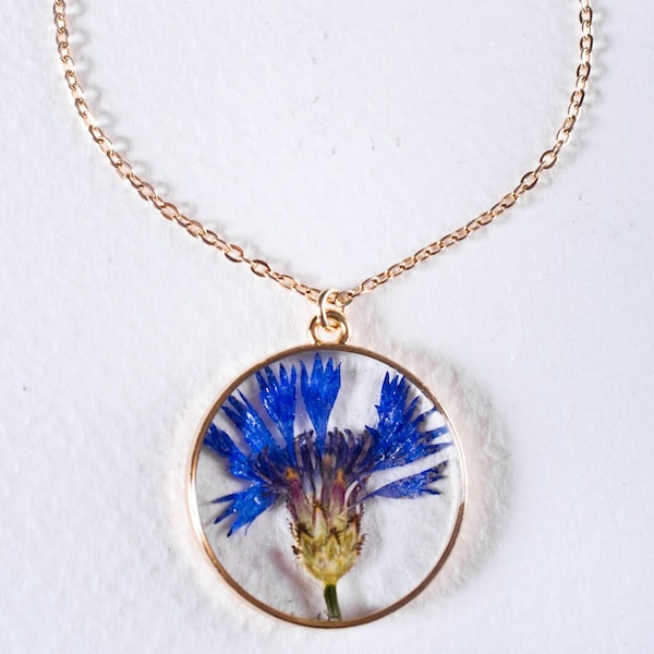 Delicate resin pendant with lovely corn flower