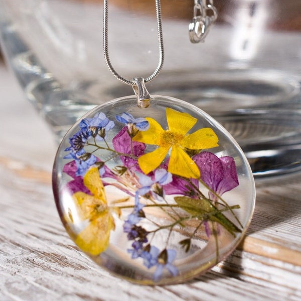 Delicate red resin pendant with pressed flowers