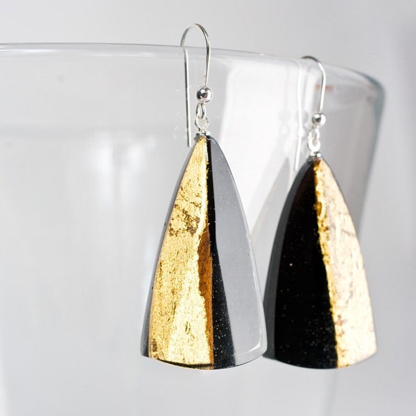 Delicate earrings with a piece of wood. Black resin and gold