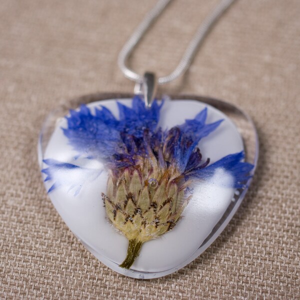 Delicate resin pendant with cornflower with white resin