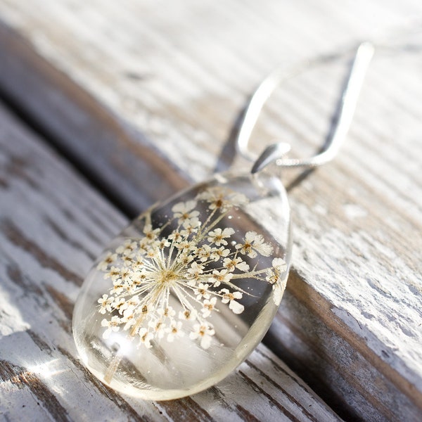Delicate resin pendant with pressed white flower