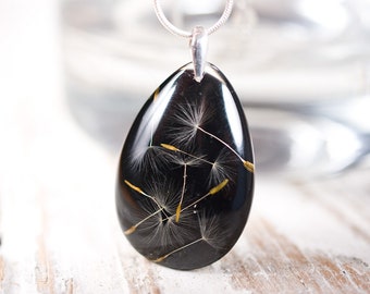 Black delicate resin pendant with dried dandelion seeds