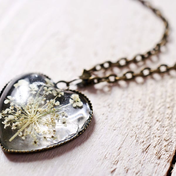 A beautiful little heart shape necklace with white flowers