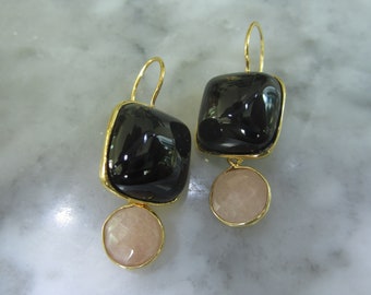 May include: A pair of gold earrings with black and pink square and round gemstones.