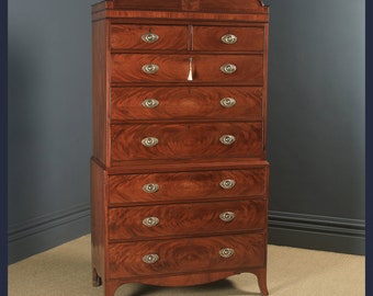 May include: A tall, antique mahogany chest of drawers with eight drawers and brass hardware. The chest has a curved top and sits on four legs.