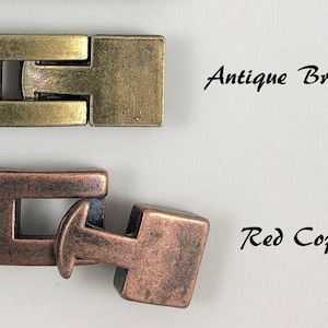 May include: Two metal clasps, one in antique bronze and one in red copper. The clasps are designed to be used for jewelry making.