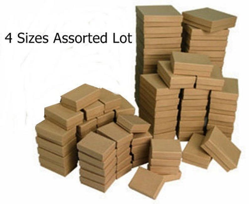 May include: A lot of brown cardboard boxes in four different sizes. The boxes are stacked on top of each other. The text "4 Sizes Assorted Lot" is visible in the image.