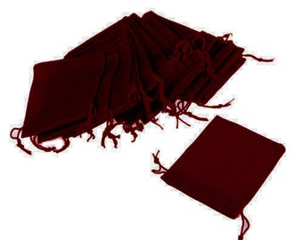 May include: A stack of 20 burgundy velvet drawstring pouches. The pouches are made of soft, luxurious velvet and are perfect for packaging small gifts or favors.