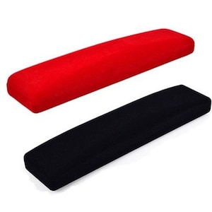 May include: Two rectangular velvet cushions, one red and one black. The cushions are made of soft, plush fabric and are perfect for adding a touch of comfort and style to any space.