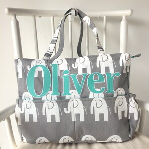 May include: Gray diaper bag with white elephant print and a turquoise name tag that says "Oliver".